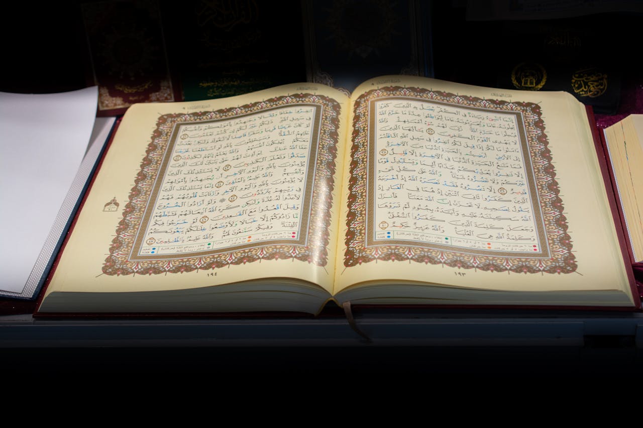 Open Quran with intricate Arabic script, beautifully displayed on a pulpit. Perfect for educational and religious themes.