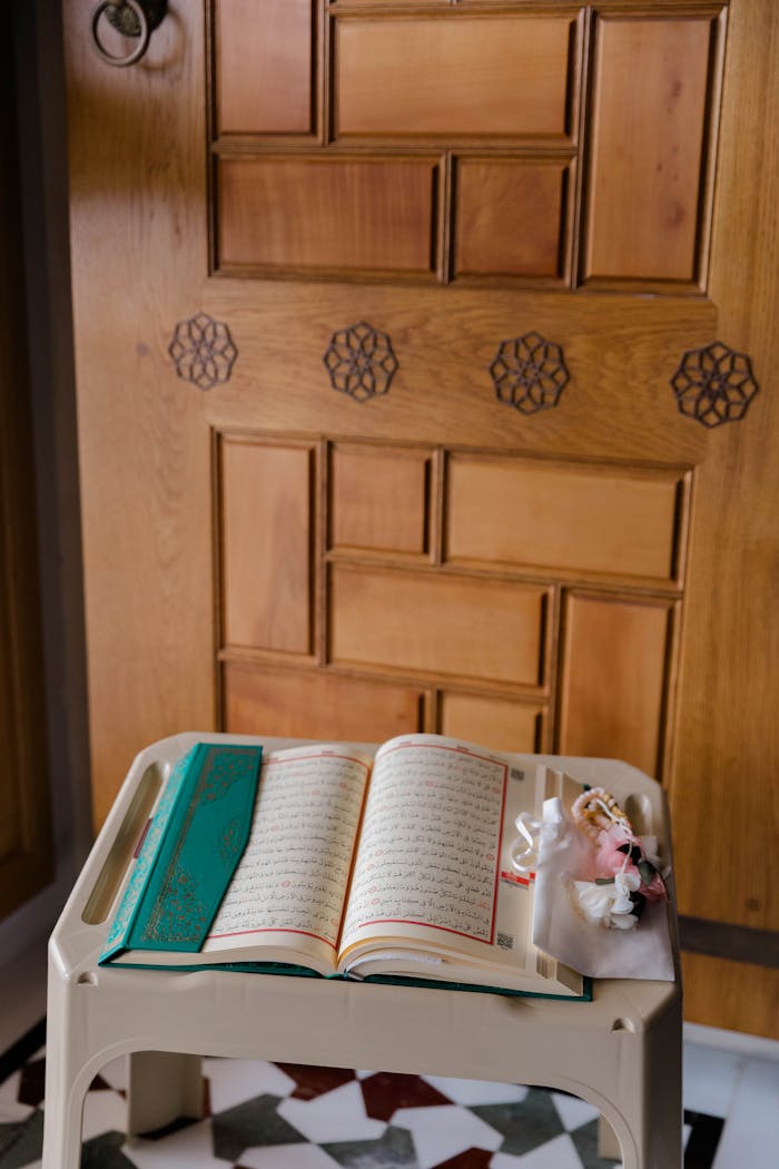 Open Quran placed elegantly on a stand in a peaceful indoor setting.